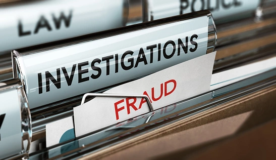 Close-up of filing cabinet with labels: "Investigations" and "Fraud" on file folders.