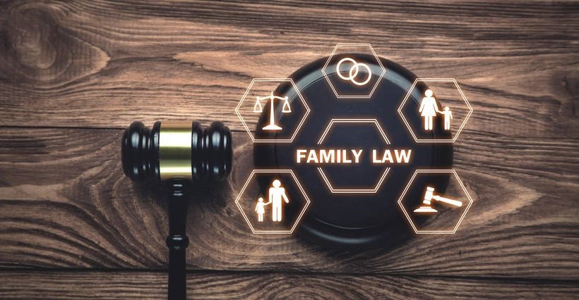 A gavel beside hexagonal icons representing family law concepts on a wooden surface.